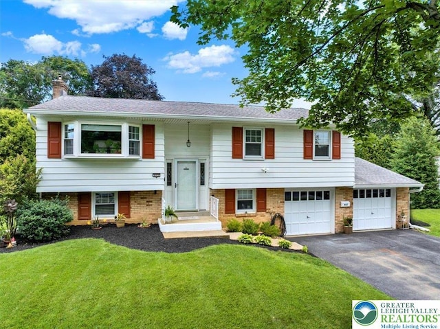 812 Miller St, Salisbury Twp, PA 18103 - split foyer home with driveway, a chimney, a front yard, and a garage