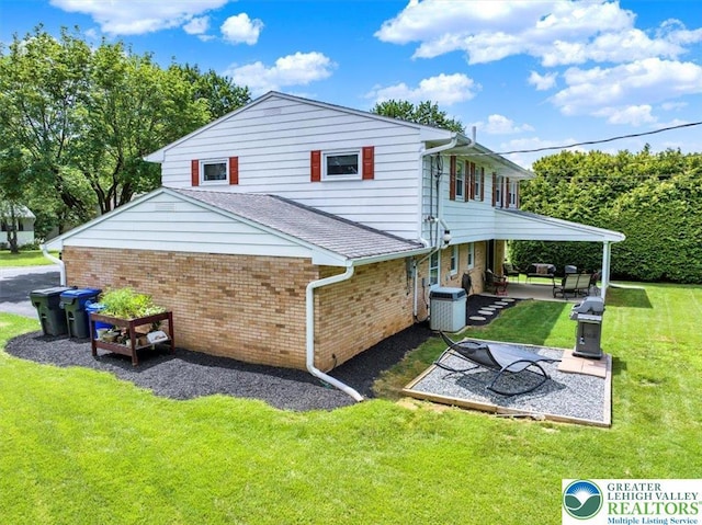 812 Miller St, Salisbury Twp, PA 18103 - back of house with a patio, brick siding, and a lawn