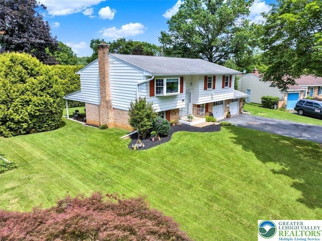 812 Miller St, Salisbury Twp, PA 18103 - split foyer home featuring a chimney, a garage, driveway, and a front lawn