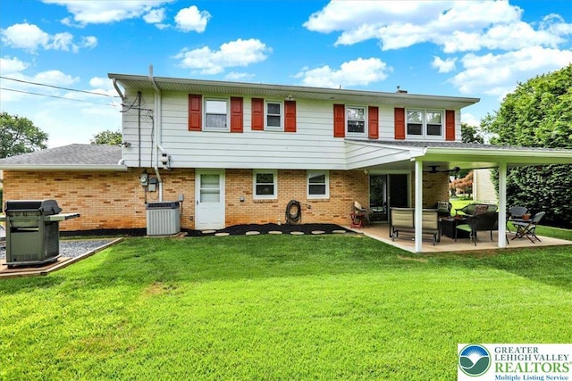 812 Miller St, Salisbury Twp, PA 18103 - back of property featuring brick siding, a ceiling fan, a patio, and a yard