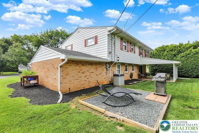 812 Miller St, Salisbury Twp, PA 18103 - rear view of house featuring a lawn, brick siding, and a patio