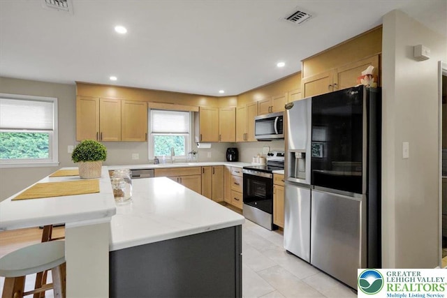 812 Miller St, Salisbury Twp, PA 18103 - kitchen with stainless steel appliances, light brown cabinets, healthy amount of natural light, and recessed lighting