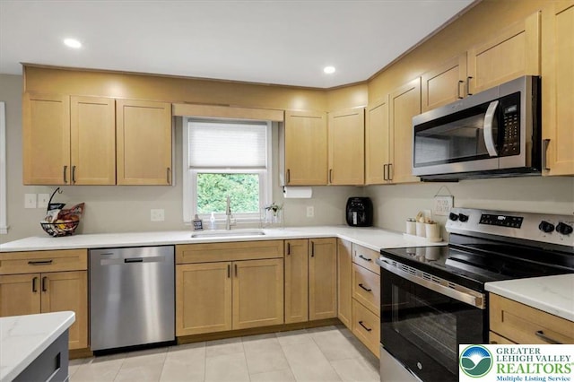 812 Miller St, Salisbury Twp, PA 18103 - kitchen with appliances with stainless steel finishes, light brown cabinetry, light stone countertops, light tile patterned floors, and recessed lighting