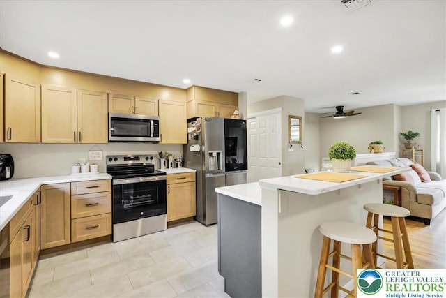 812 Miller St, Salisbury Twp, PA 18103 - kitchen featuring appliances with stainless steel finishes, open floor plan, a breakfast bar, ceiling fan, and light countertops