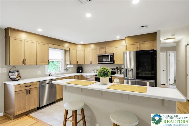 812 Miller St, Salisbury Twp, PA 18103 - kitchen featuring appliances with stainless steel finishes, a kitchen breakfast bar, light countertops, and recessed lighting