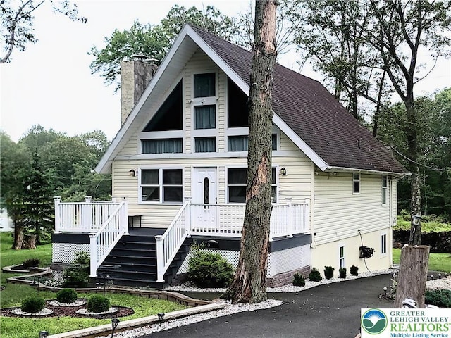 1025 Cricket Ln, Tobyhanna Twp, PA 18334 - view of front of house with a chimney, a wooden deck, and a shingled roof