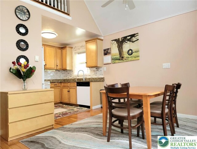 1025 Cricket Ln, Tobyhanna Twp, PA 18334 - kitchen with dishwasher, light wood-style flooring, vaulted ceiling, tasteful backsplash, and ceiling fan