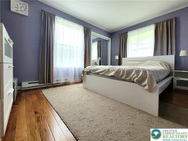 1025 Cricket Ln, Tobyhanna Twp, PA 18334 - bedroom with a baseboard radiator, wood finished floors, and a closet