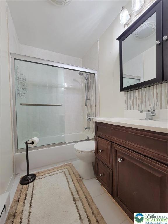 1025 Cricket Ln, Tobyhanna Twp, PA 18334 - bathroom featuring vanity, enclosed tub / shower combo, and tile patterned flooring