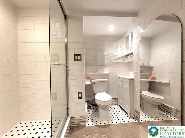 1025 Cricket Ln, Tobyhanna Twp, PA 18334 - bathroom featuring tile walls, a stall shower, vanity, and tile patterned flooring