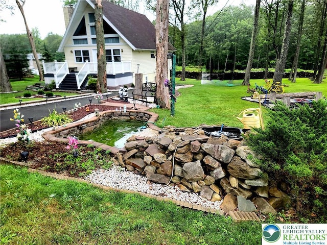 1025 Cricket Ln, Tobyhanna Twp, PA 18334 - view of grassy yard featuring a wooden deck