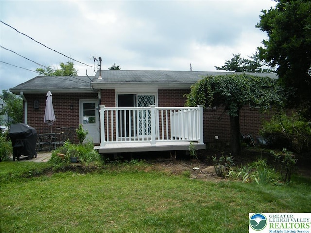 3415 Kathleen Ave, Salisbury Twp, PA 18103 - rear view of house with brick siding, a yard, and a deck