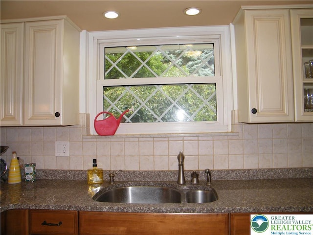 3415 Kathleen Ave, Salisbury Twp, PA 18103 - kitchen featuring cream cabinetry, glass insert cabinets, and dark stone countertops