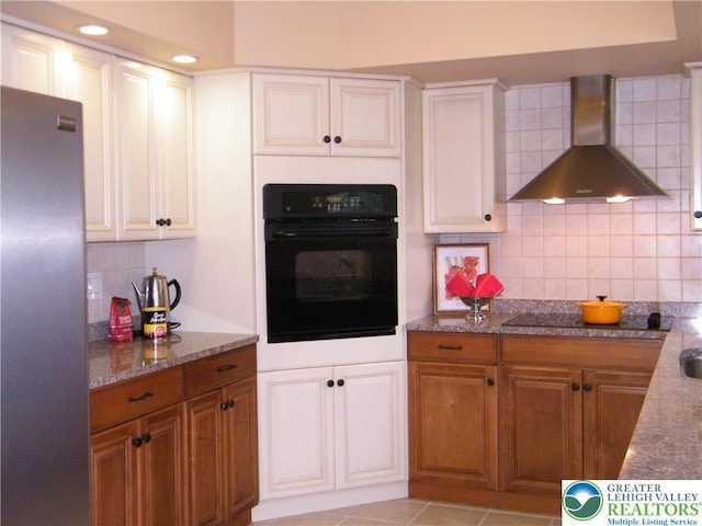 3415 Kathleen Ave, Salisbury Twp, PA 18103 - kitchen featuring black appliances, wall chimney exhaust hood, tasteful backsplash, stone counters, and brown cabinetry