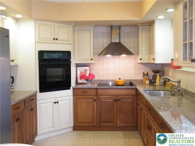 3415 Kathleen Ave, Salisbury Twp, PA 18103 - kitchen featuring black appliances, wall chimney range hood, brown cabinets, tasteful backsplash, and stone counters