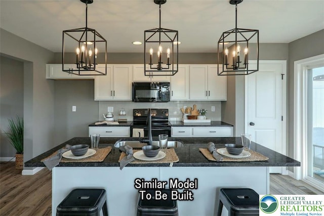 3229 Tepes Dr Lot 138, Allen Twp, PA 18067 - kitchen featuring black appliances, light wood-style flooring, white cabinets, tasteful backsplash, and recessed lighting
