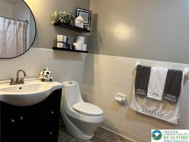 3300 Quarry St Unit B4, Whitehall Twp, PA 18052 - bathroom featuring tile walls, vanity, and a wainscoted wall