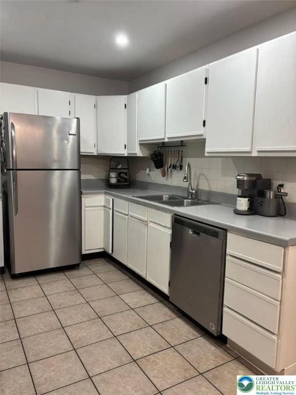 3300 Quarry St Unit B4, Whitehall Twp, PA 18052 - kitchen with appliances with stainless steel finishes, white cabinetry, backsplash, and light countertops