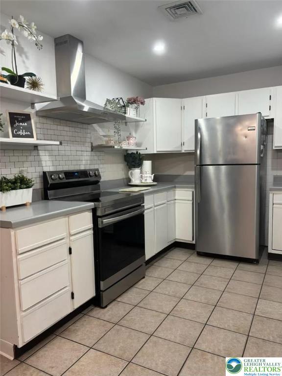 3300 Quarry St Unit B4, Whitehall Twp, PA 18052 - kitchen featuring freestanding refrigerator, range with electric cooktop, island range hood, open shelves, and tasteful backsplash