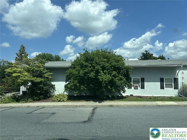 3300 Quarry St Unit B4, Whitehall Twp, PA 18052 - view of property hidden behind natural elements featuring stucco siding and roof with shingles