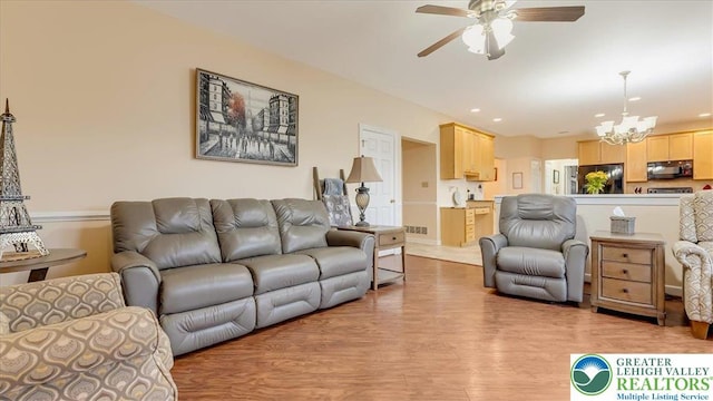2804 Lehigh Ln, Upper Nazareth Twp, PA 18064 - living room featuring a ceiling fan, a chandelier, light wood finished floors, and recessed lighting
