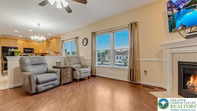 2804 Lehigh Ln, Upper Nazareth Twp, PA 18064 - living room with a chandelier, light wood-style floors, a ceiling fan, a tile fireplace, and recessed lighting
