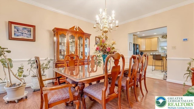 2804 Lehigh Ln, Upper Nazareth Twp, PA 18064 - dining space featuring a chandelier, ornamental molding, and light wood-style flooring