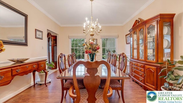 2804 Lehigh Ln, Upper Nazareth Twp, PA 18064 - dining space featuring wood finished floors, a chandelier, and crown molding