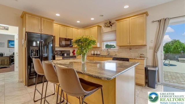 2804 Lehigh Ln, Upper Nazareth Twp, PA 18064 - kitchen with black appliances, light brown cabinets, a center island, dark stone countertops, and recessed lighting