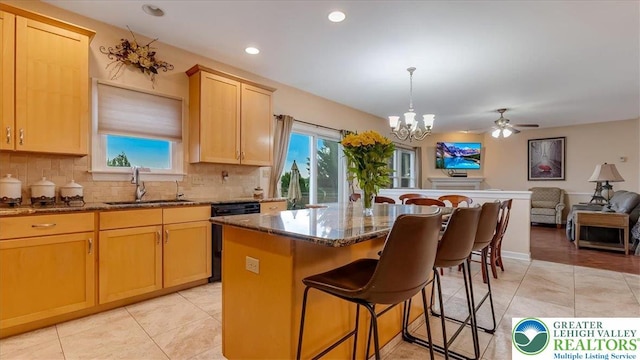 2804 Lehigh Ln, Upper Nazareth Twp, PA 18064 - kitchen with black dishwasher, a chandelier, a breakfast bar area, a center island, and backsplash