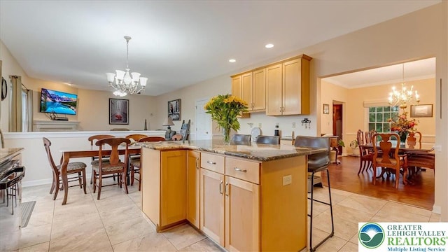 2804 Lehigh Ln, Upper Nazareth Twp, PA 18064 - kitchen featuring a chandelier, a kitchen breakfast bar, light tile patterned floors, light brown cabinets, and recessed lighting