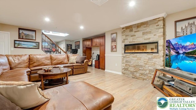 2804 Lehigh Ln, Upper Nazareth Twp, PA 18064 - living room with light wood-type flooring, stairs, a stone fireplace, and recessed lighting