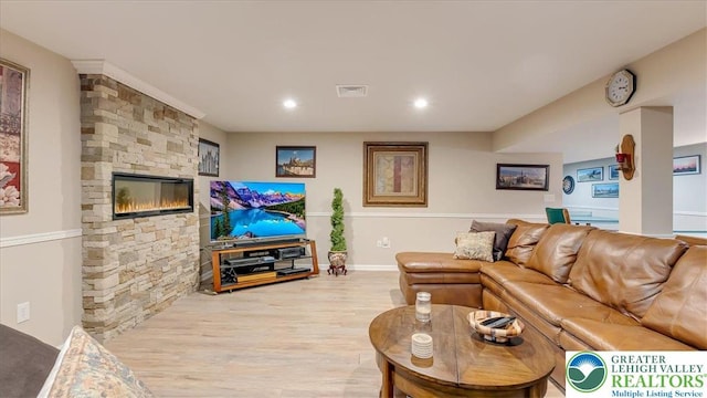 2804 Lehigh Ln, Upper Nazareth Twp, PA 18064 - living room featuring wood finished floors, recessed lighting, and a stone fireplace