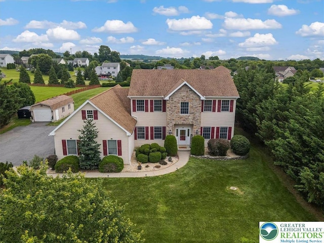 2804 Lehigh Ln, Upper Nazareth Twp, PA 18064 - colonial inspired home with stone siding, a front yard, an outbuilding, and a garage