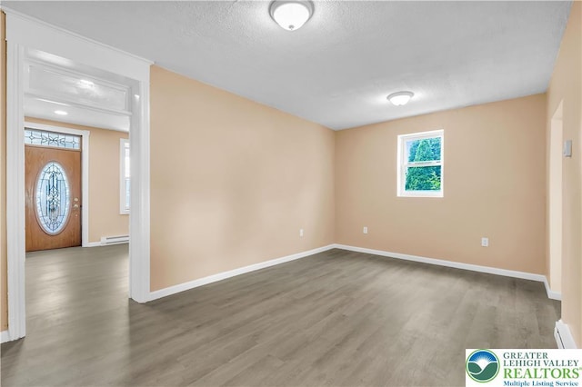 5734 Rte 873, North Whitehall Twp, PA 18078 - spare room with wood finished floors, a textured ceiling, and baseboard heating