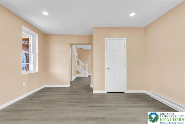 5734 Rte 873, North Whitehall Twp, PA 18078 - empty room featuring baseboard heating, wood finished floors, recessed lighting, and stairway