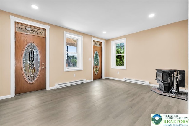 5734 Rte 873, North Whitehall Twp, PA 18078 - foyer entrance with baseboard heating, wood finished floors, a wood stove, and recessed lighting