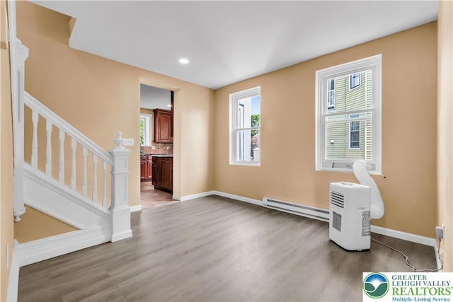 5734 Rte 873, North Whitehall Twp, PA 18078 - unfurnished living room with a baseboard radiator, wood finished floors, healthy amount of natural light, stairs, and recessed lighting