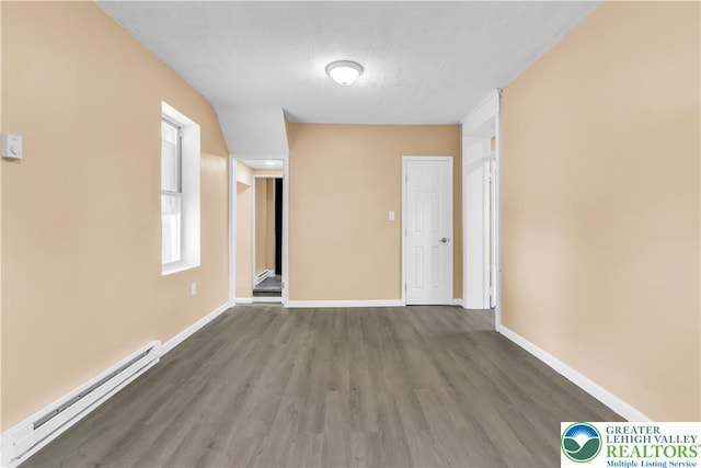 5734 Rte 873, North Whitehall Twp, PA 18078 - spare room with a baseboard heating unit, wood finished floors, and a textured ceiling