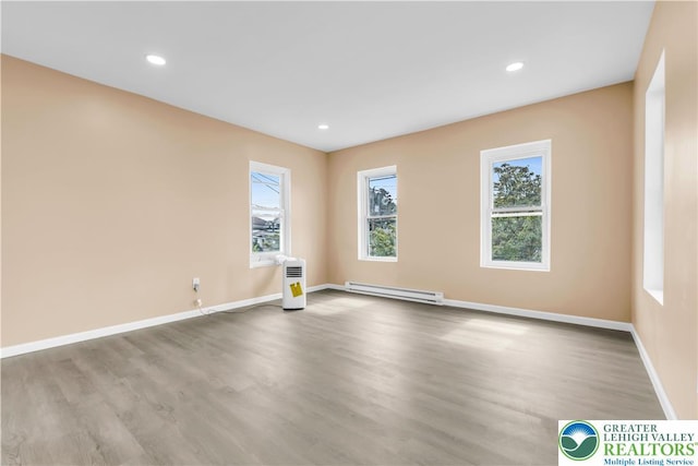 5734 Rte 873, North Whitehall Twp, PA 18078 - unfurnished room with a baseboard radiator, wood finished floors, and recessed lighting