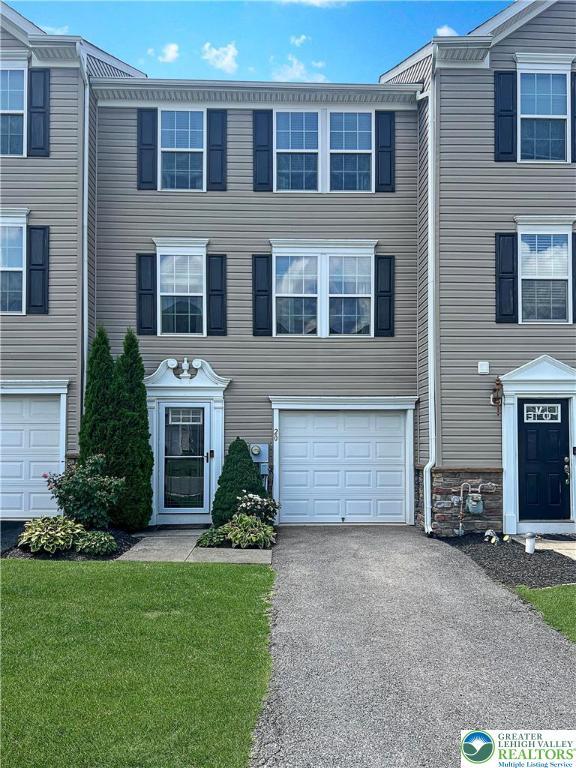 20 Gold Rose Ln, Palmer Twp, PA 18045 - colonial-style house with a garage, driveway, a front yard, and stone siding