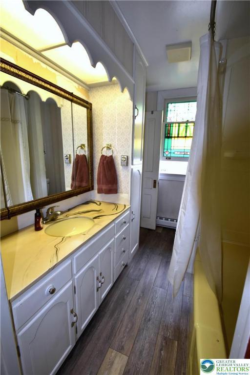 107 N Schanck Ave, Pen Argyl Boro, PA 18072 - bathroom featuring vanity, wood finished floors, and a baseboard heating unit
