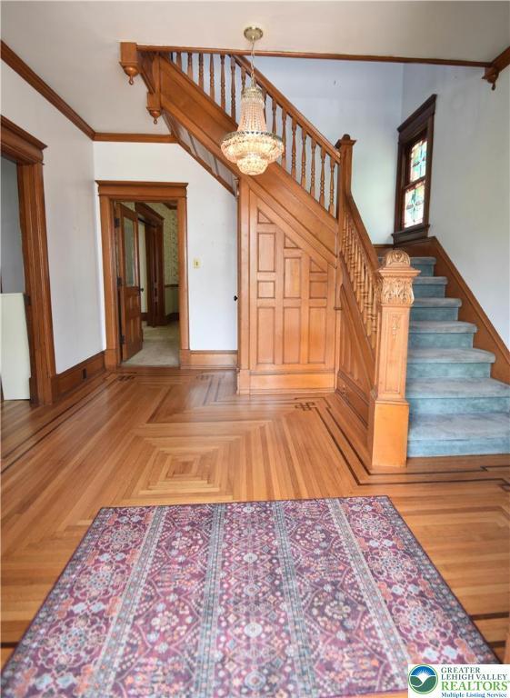 107 N Schanck Ave, Pen Argyl Boro, PA 18072 - stairway with crown molding and a chandelier