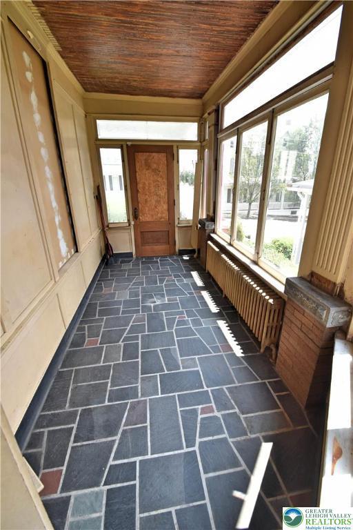 107 N Schanck Ave, Pen Argyl Boro, PA 18072 - unfurnished sunroom featuring radiator heating unit