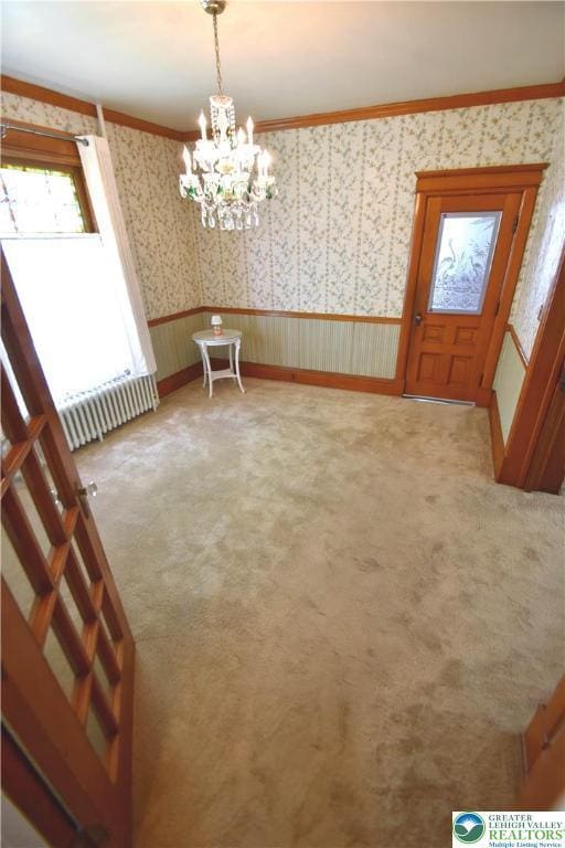 107 N Schanck Ave, Pen Argyl Boro, PA 18072 - unfurnished dining area with radiator, wallpapered walls, light colored carpet, a chandelier, and ornamental molding