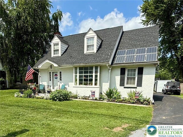 23 Main St, Stockertown Boro, PA 18040 - new england style home featuring a shingled roof, a front lawn, and brick siding
