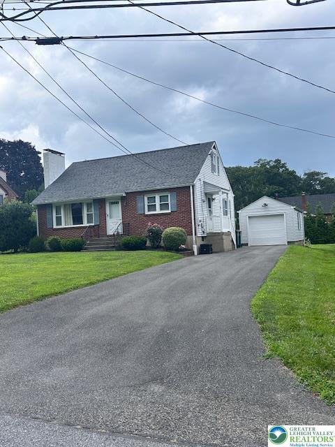 2653 Woodlawn Ave, Palmer Twp, PA 18045 - view of front of property with a detached garage, asphalt driveway, an outbuilding, brick siding, and a chimney