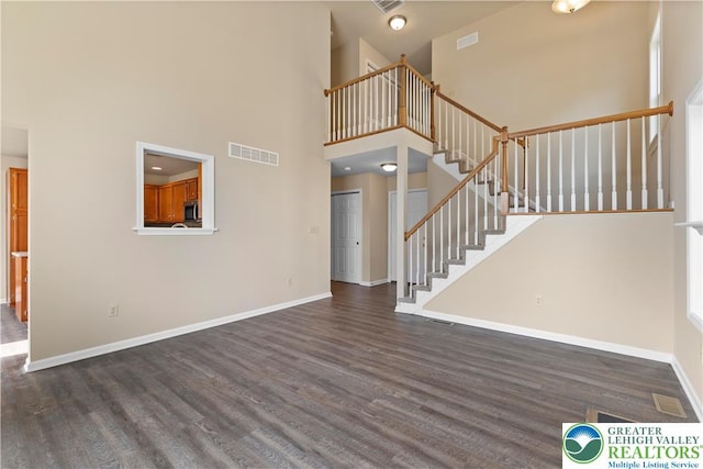 9 Stone Crk, Palmer Twp, PA 18045 - unfurnished living room with wood finished floors, a high ceiling, and stairway
