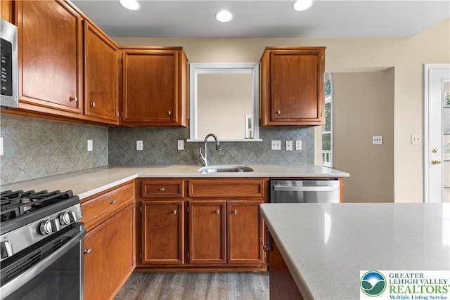 9 Stone Crk, Palmer Twp, PA 18045 - kitchen featuring wood finished floors, light countertops, decorative backsplash, appliances with stainless steel finishes, and brown cabinetry