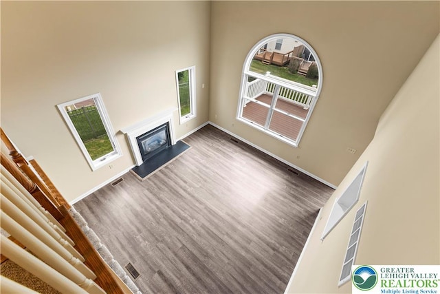 9 Stone Crk, Palmer Twp, PA 18045 - unfurnished living room with plenty of natural light, wood finished floors, and a glass covered fireplace